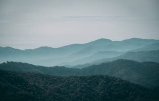 A foggy mountainous scenery under the gloomy sky